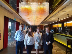 На снимката с българския посланик в държавата - джудже, в Индонезия, Малайзия и Тимор Петър Андонов, до нея вдясно, тя демонстрира съвършената си фигура от годините на спорта, въпреки че 3 десетилетия не е на килима